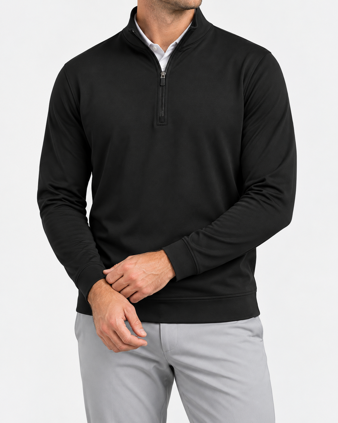 Model wearing the black Blackthorn quarter-zip over a white polo with light grey golf trousers.
