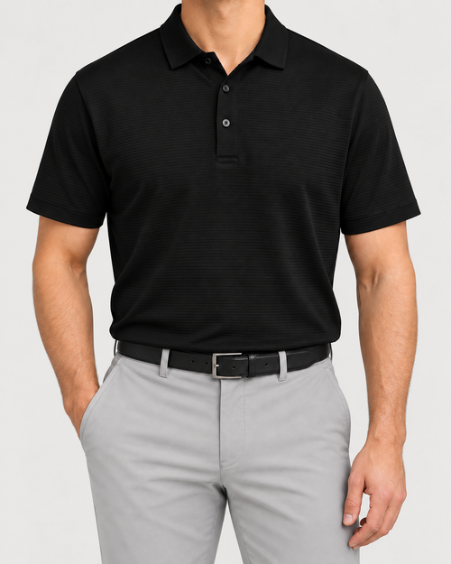 Palvento Blackheath black golf polo worn with light grey trousers and a black belt.