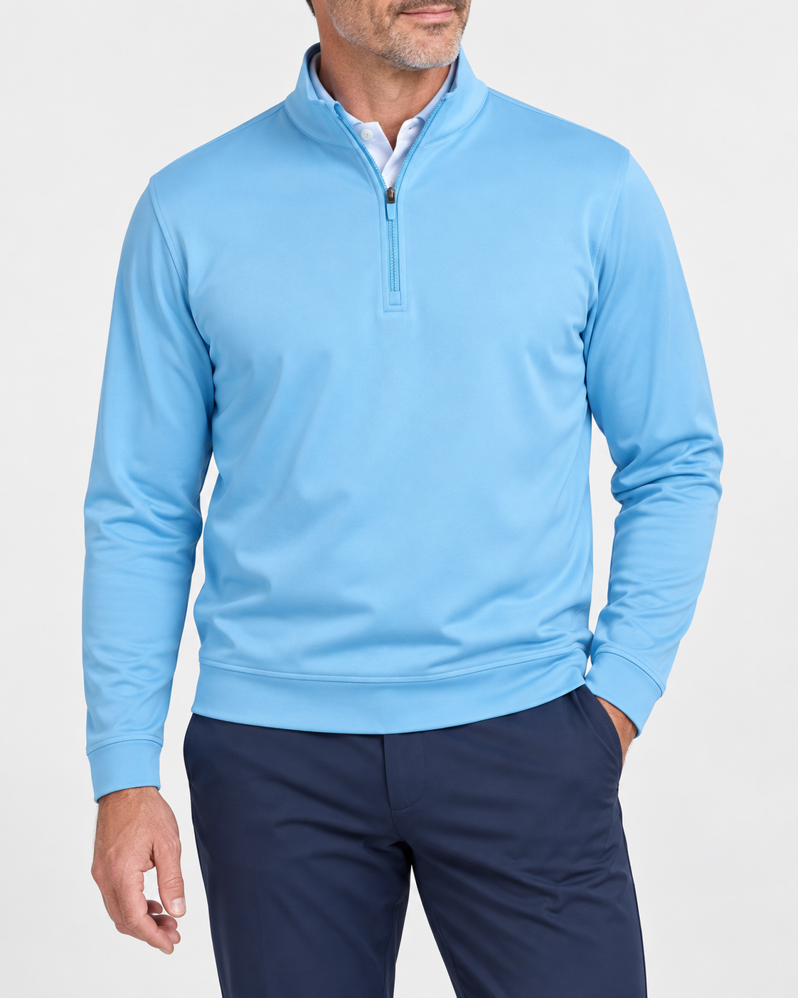 Model wearing the light blue Dunwich quarter-zip over a white polo with navy golf trousers.