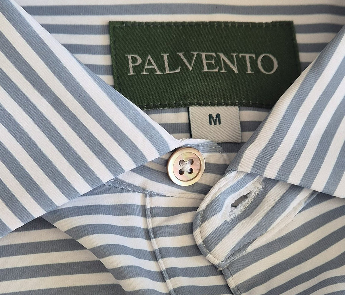 Close-up of Palvento Golf's signature woven hem tag on a premium men's golf polo shirt, highlighting the understated branding and attention to detail.