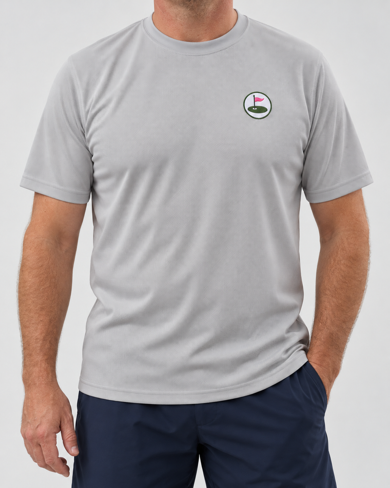 Model wearing the grey Seabury performance tee with embroidered chest roundel and navy shorts.