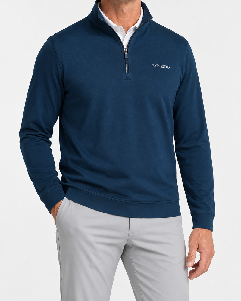 Model wearing the navy Southdown quarter-zip over a white polo with light grey golf trousers.