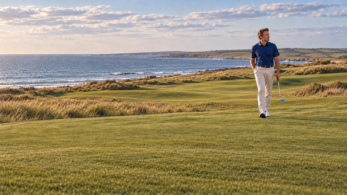 Golfer wearing a navy Palvento golf polo on a British links course, showcasing classic men's golfwear and understated style.