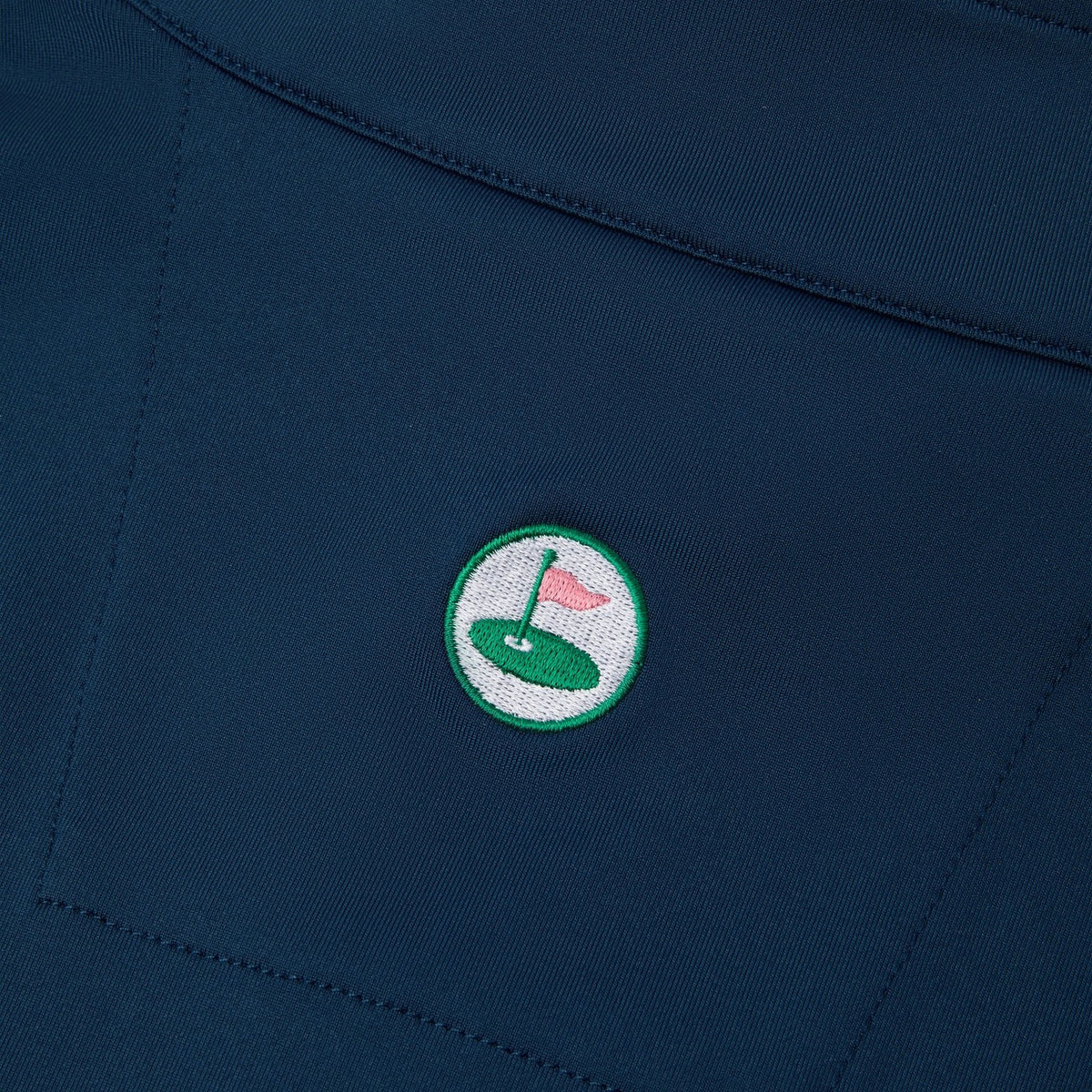 Palvento embroidered roundel on the rear yoke of a navy performance garment