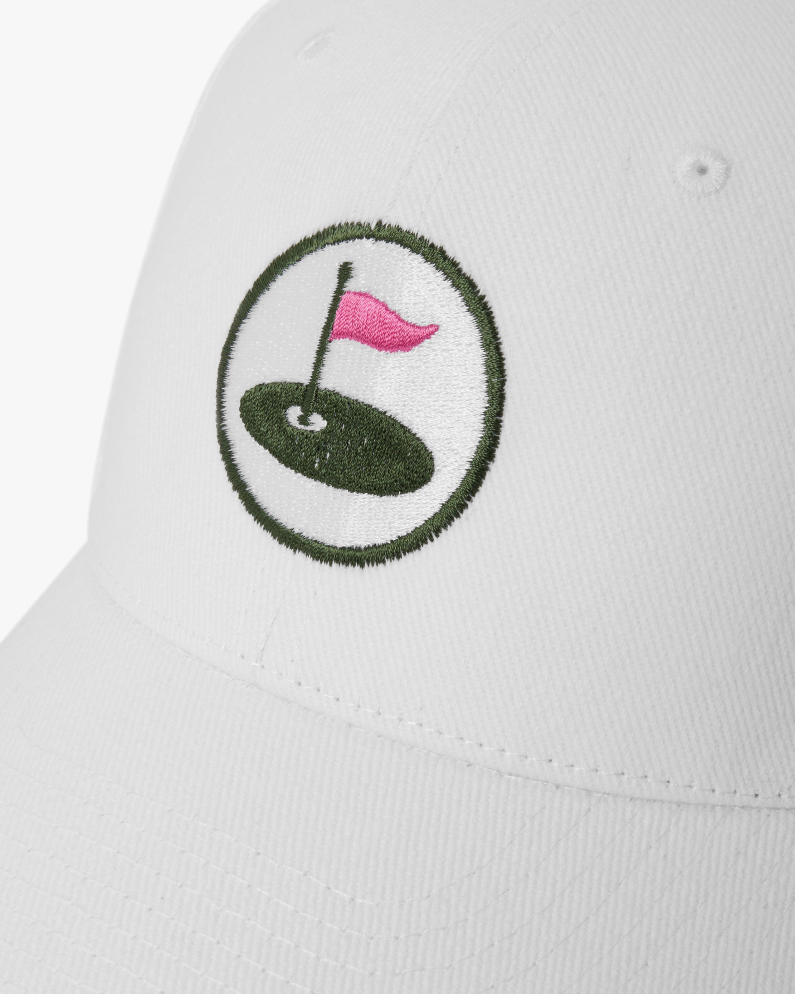 White cap with a golf-themed embroidered design on a white background